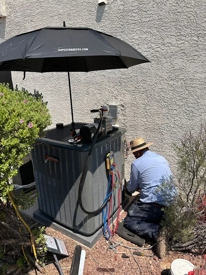 HVAC technician performing outdoor AC maintenance in Perth Amboy