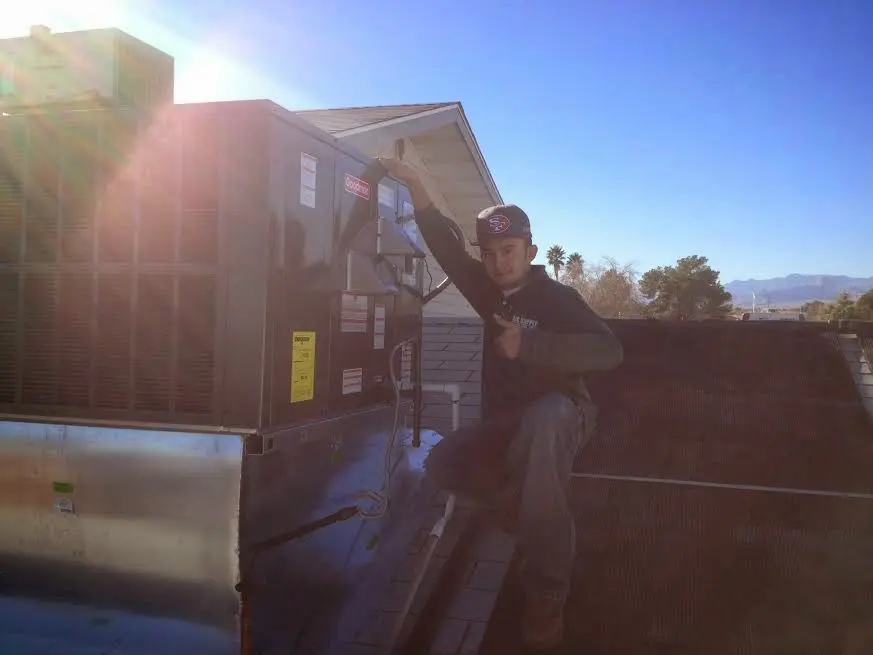 HVAC technician performing AC Tune-Up on a rooftop unit in Perth Amboy